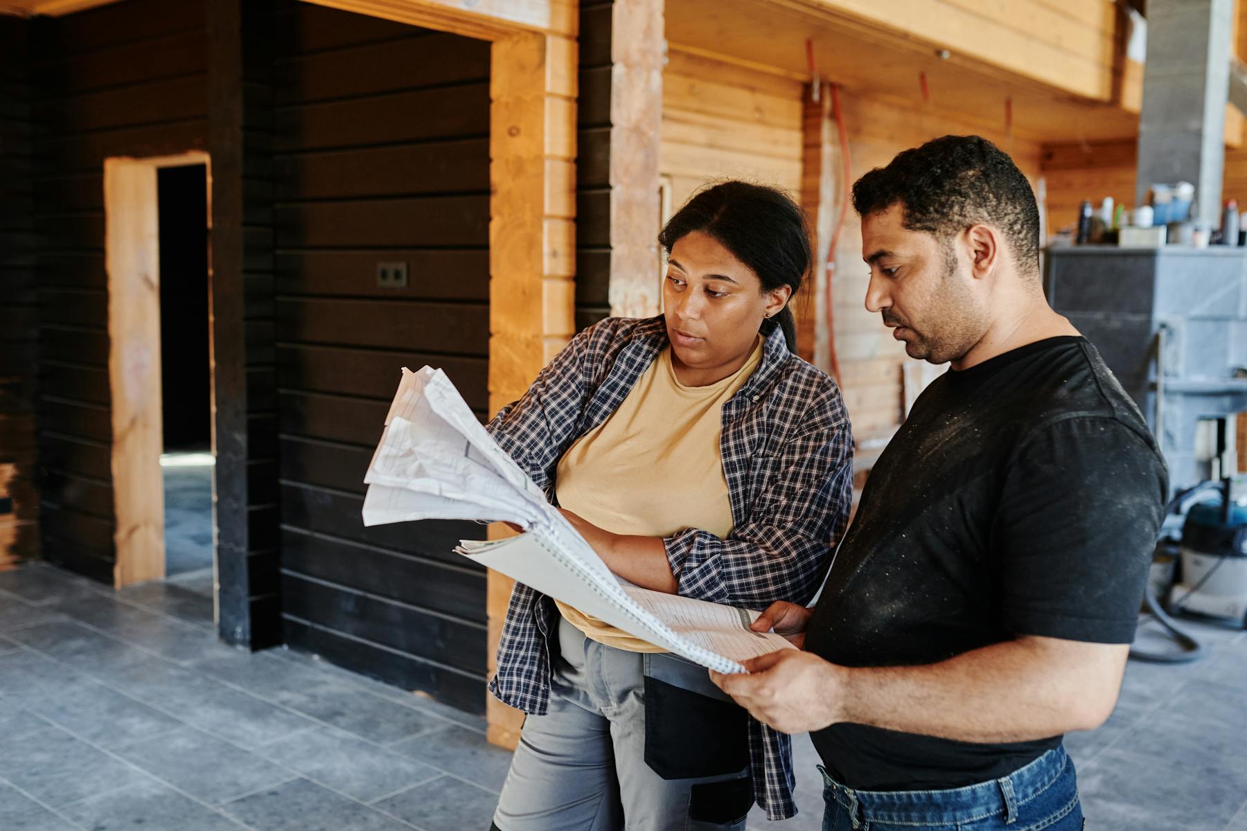 Construction workers reviewing plans before a project moves forward
